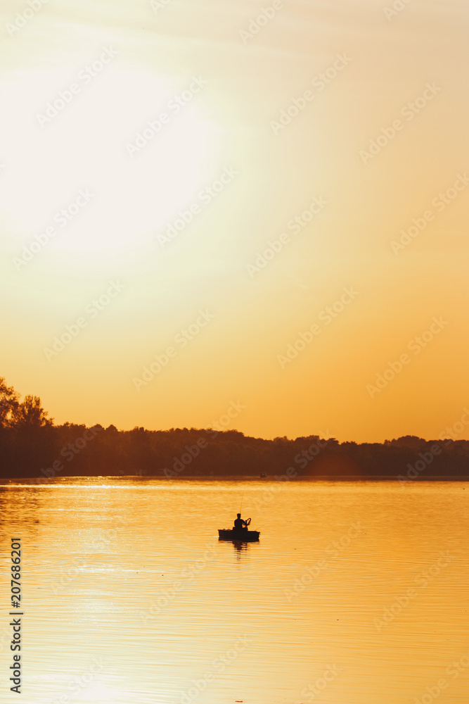 Silhouette of fisherman during sunset