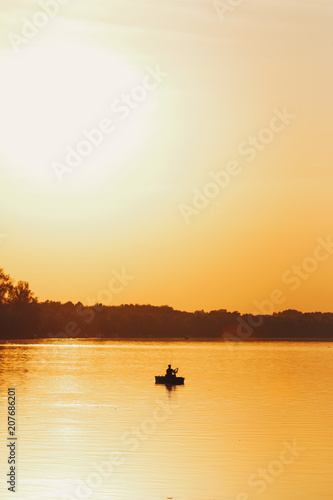 Silhouette of fisherman during sunset © Omar