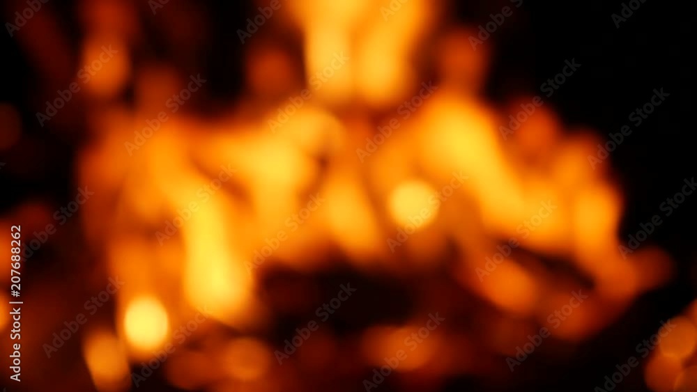 Blurry bright sparking bokeh video of a burning campfire at night in 4K resolution. Blurry bright sparking bokeh video of a burning campfire at night in 4K resolution.
