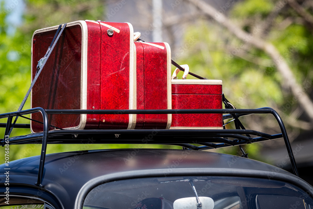 Vintage luggage in a car top carrier roof of car Stock Photo