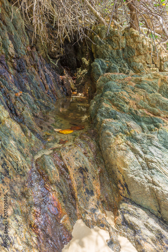 Small clean water lake between a rock