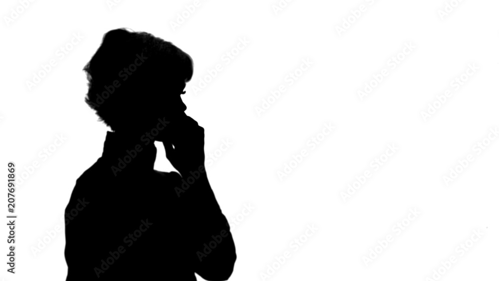 Silhouette Happy businesswoman speaking at the phone track matte