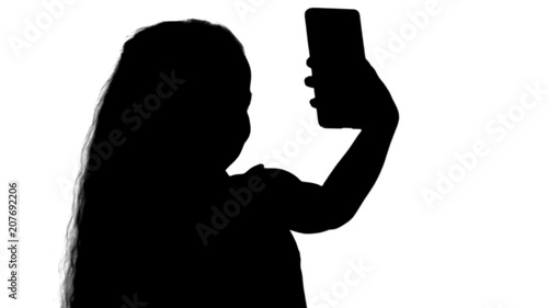 Silhouette Little cute girl smile and taking selfie track matte