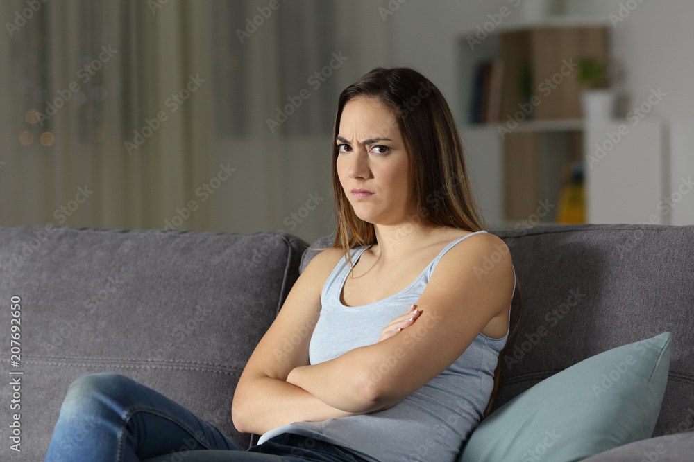 Angry woman looking at you in the night at home Angry woman looking at you in the night at home