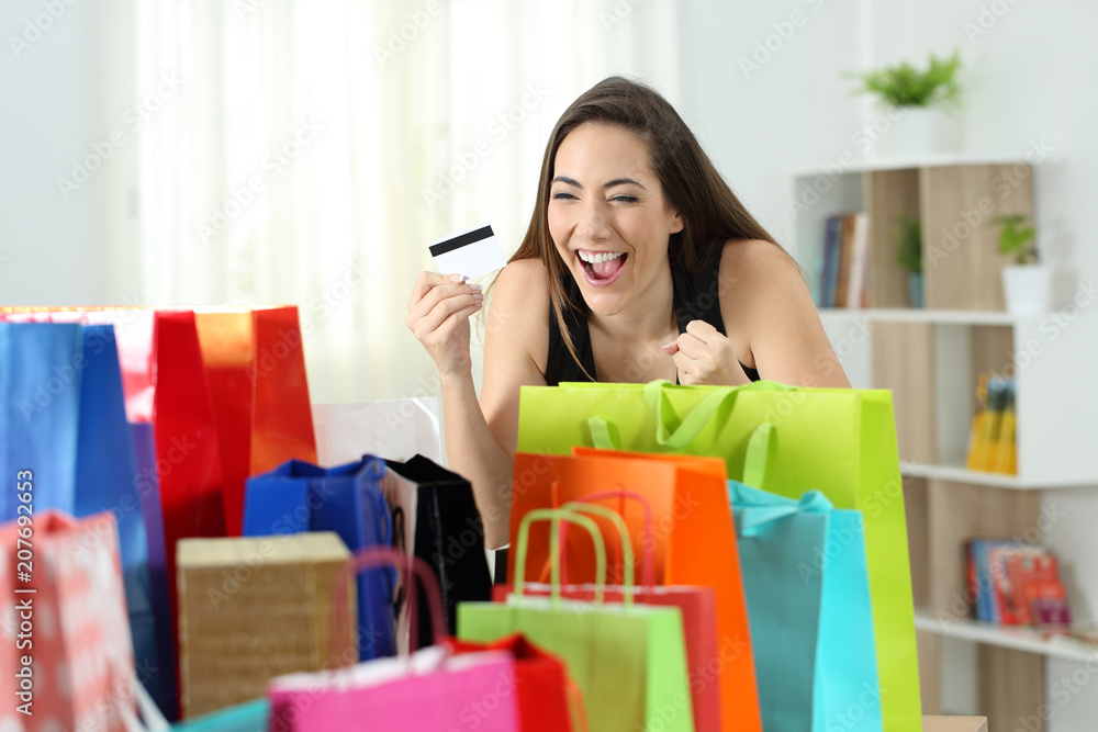 Excited shopper looking at multiple purchases Excited shopper looking at multiple purchases