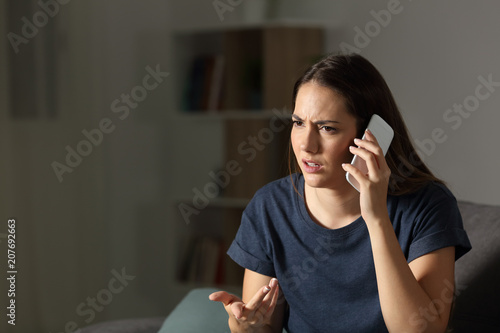 Frustrated woman claiming on the phone in the night
