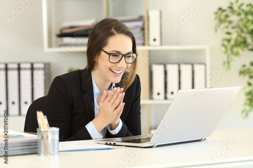 Happy office worker receiving good online news