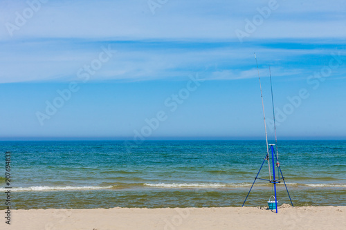 Fishing rod left alone on sea shore © anetlanda