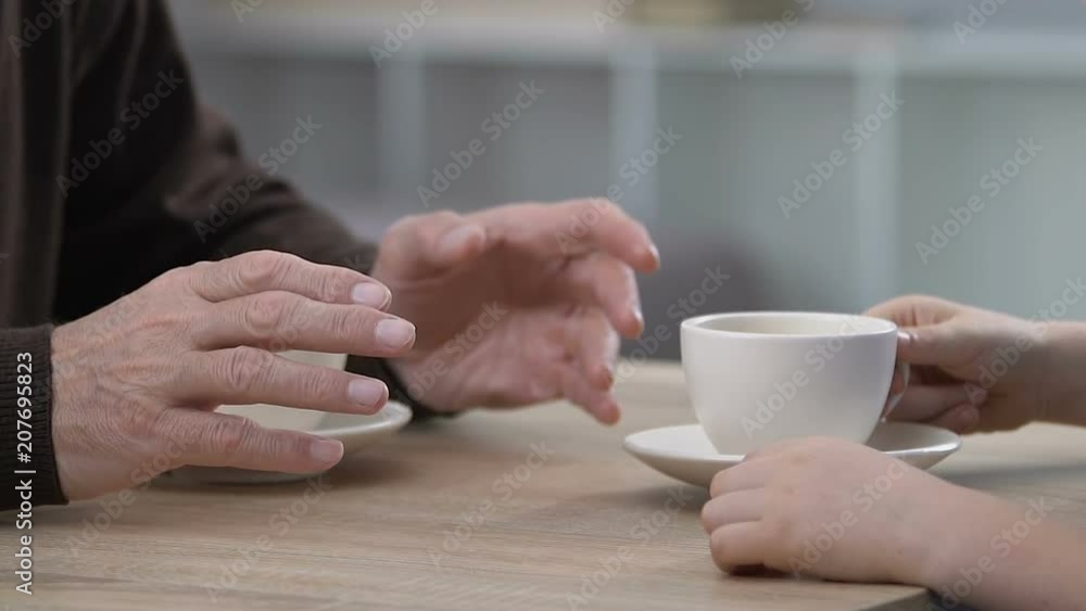 Grandpa and kid talking and drinking tea, spending time together, communication Grandpa and kid talking and drinking tea, spending time together, communication