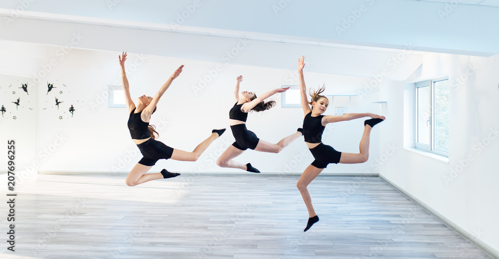 Fototapeta premium The group of beautiful girls practicing modern ballet dance.