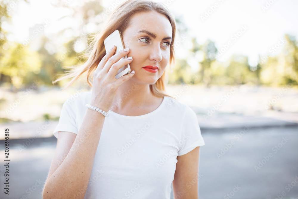 Young athletic girl, cute smiling, and talking on the phone, can be used for advertising, text input Young athletic girl, cute smiling, and talking on the phone, can be used for advertising, text input