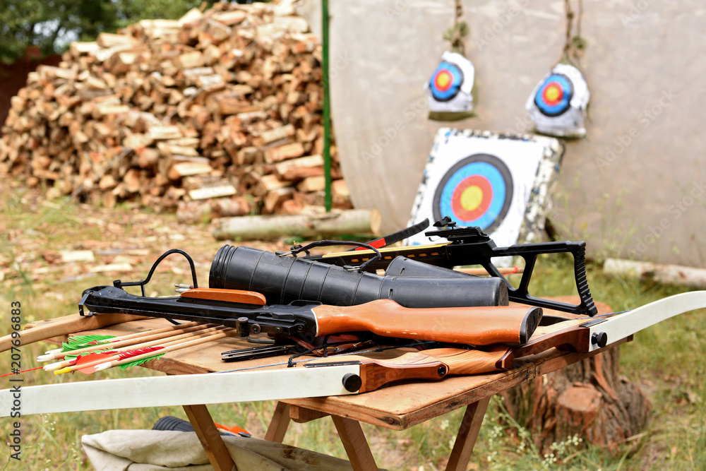archery crossbows arrows against the background of targets