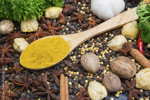Turmeric powder with variety herbs and spices © Creativa Images