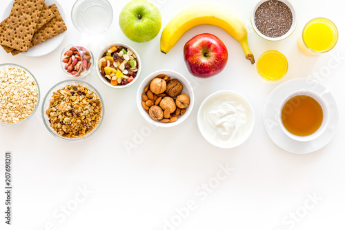 Wallpaper Mural Ingredients for healthy breakfast. Fruits, oatmeal, yogurt, nuts, crispbreads, chia on white background top view copy space Torontodigital.ca