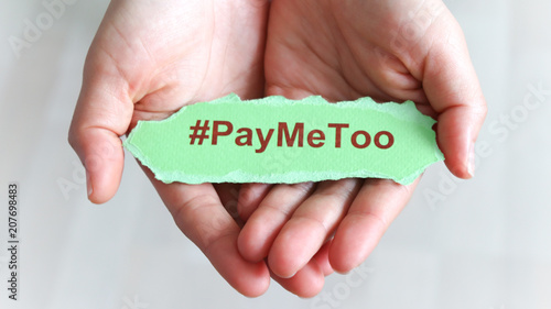 #PayMeToo as a new social movement. A piece of paper with #PayMeToo written on the palm of a woman's hand. photo