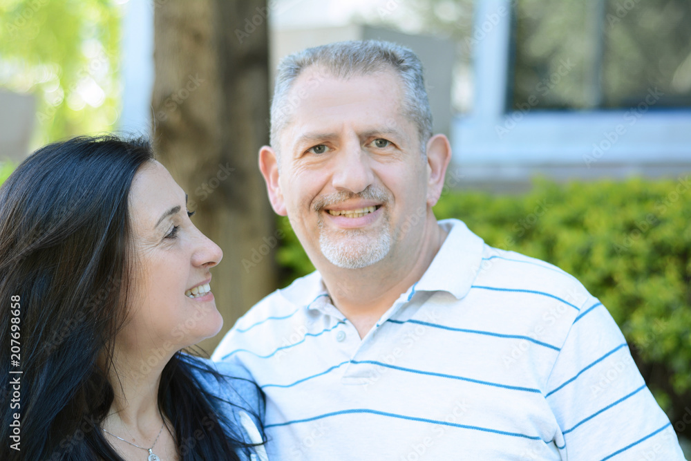 Portrait of smiling middle-aged couple looking forward Portrait of smiling middle-aged couple looking forward