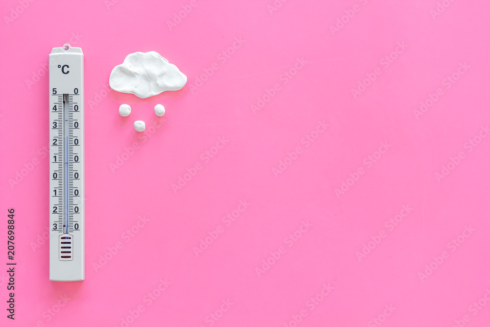 It's snow weather concept. Air temperature. Termometer near snow cloud on pink background top view copy space It's snow weather concept. Air temperature. Termometer near snow cloud on pink background top view copy space