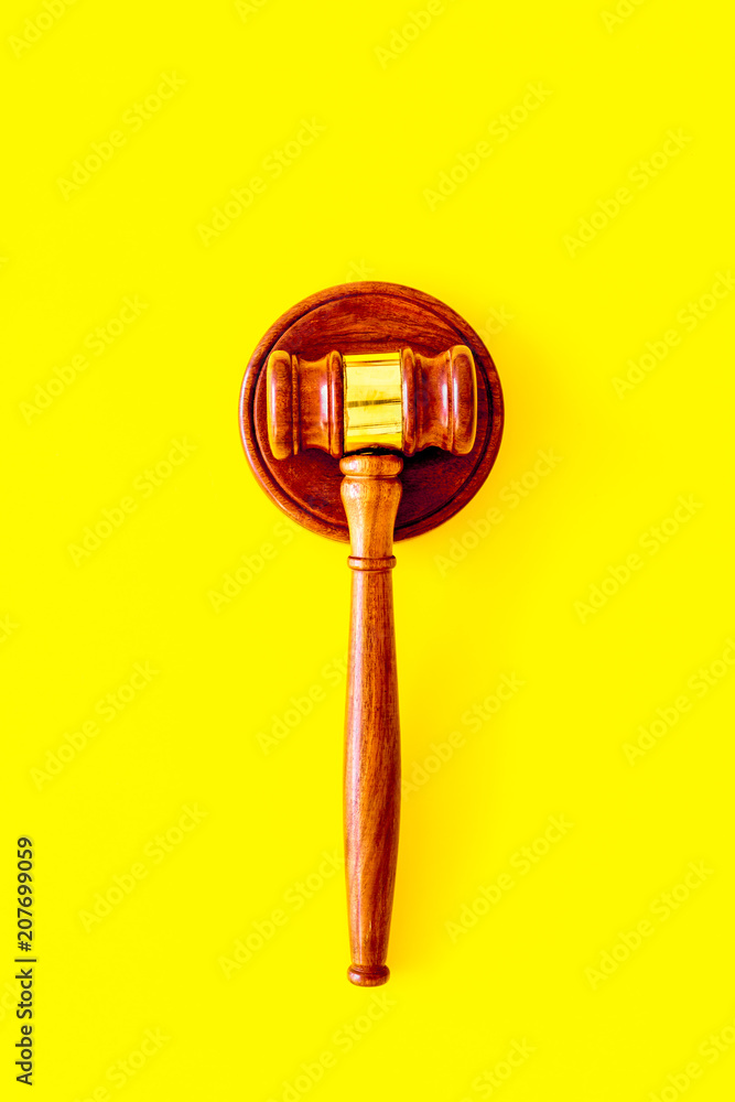 Lawyer or attorney concept. Judge gavel on yellow background top view copy space Lawyer or attorney concept. Judge gavel on yellow background top view copy space