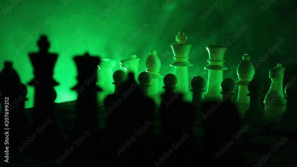 Slider shot. Chess board game concept of business ideas and competition and strategy ideas concept. Chess figures on a dark background with smoke and fog. Rotating Chessboard. Selective focus Slider shot. Chess board game concept of business ideas and competition and strategy ideas concept. Chess figures on a dark background with smoke and fog. Rotating Chessboard. Selective focus