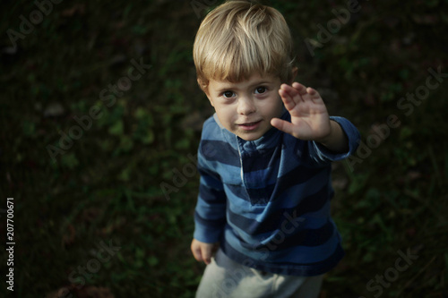Photo of adorable young happy boy looking at camera.