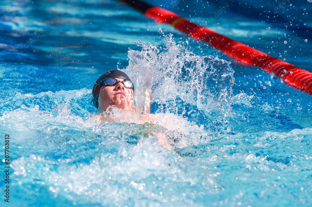 Backstroke swimmer in a race