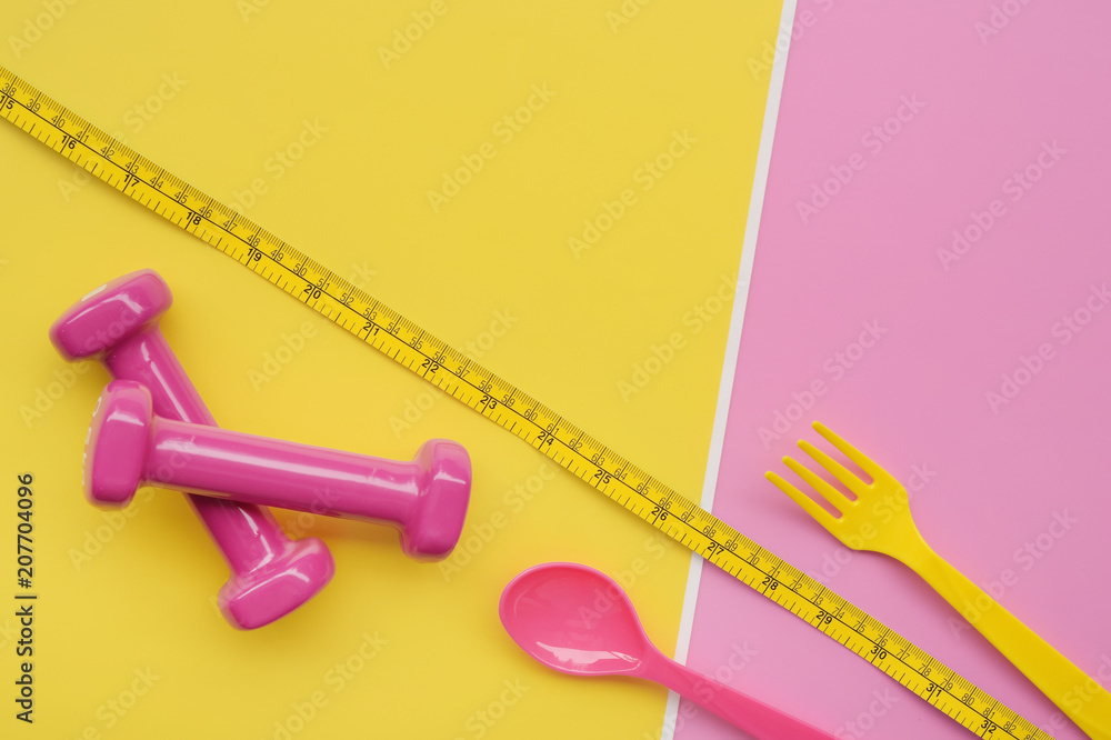 close up of spoon in tape measure with dumbbell for background close up of spoon in tape measure with dumbbell for background