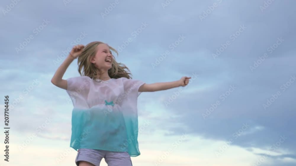 Two children dance and indulge on the beach. Children perform dancing stunts tricks. Hair fluttering in the wind. The kid spin and jump, shake their heads. One girl is a teenager. Two children dance and indulge on the beach. Children perform dancing stunts tricks. Hair fluttering in the wind. The kid spin and jump, shake their heads. One girl is a teenager.