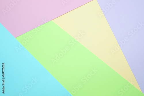 Fashionable pastel colored paper flat lay top view, geometric background texture, pink, purple, yellow, beige, green and blue.