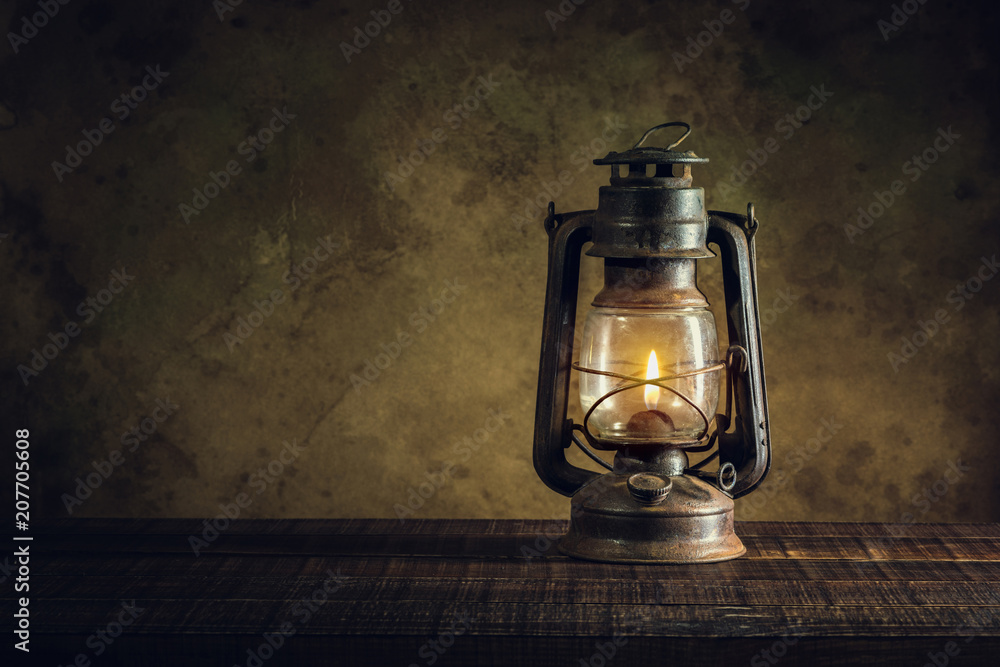 kerosene lamp oil lantern burning with glow soft light on aged wood floor  foto de Stock | Adobe Stock