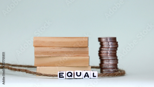 Wallpaper Mural A pile of coins and four wooden blocks. The concept of equal labor pay. Torontodigital.ca