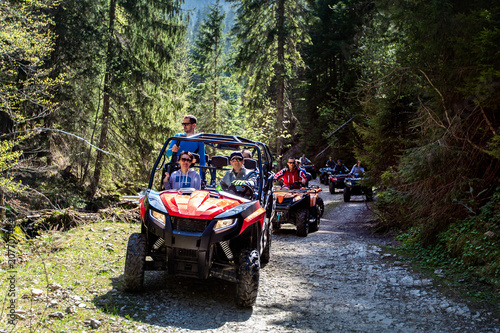 A tour group travels on ATVs and UTVs on the mountains photo
