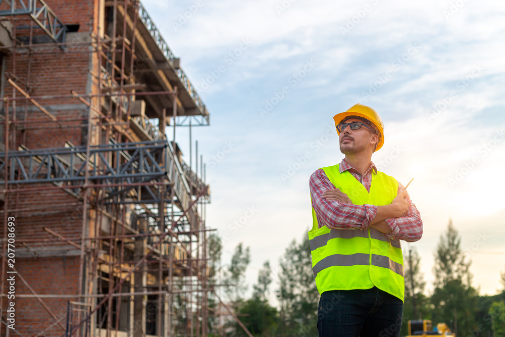 Manager Engineering in standard safety uniform working in a pouring concrete pump on construction site Manager Engineering in standard safety uniform working in a pouring concrete pump on construction site