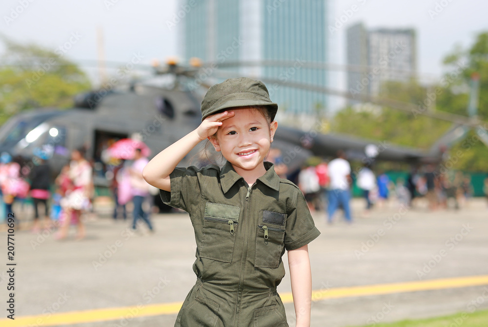 Little Asian child girl in pilot soldier suit costume. Dream job concept.