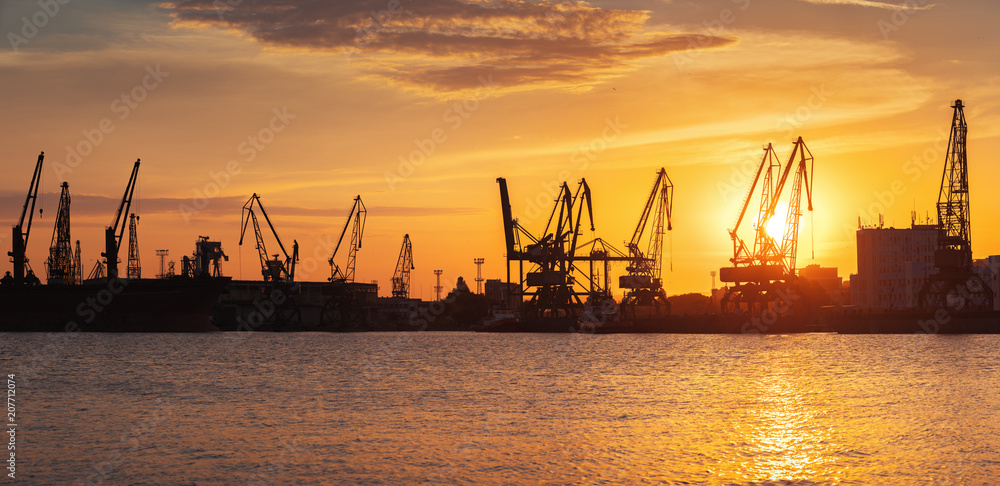 Sunset over sea port and industrial cranes, Varna