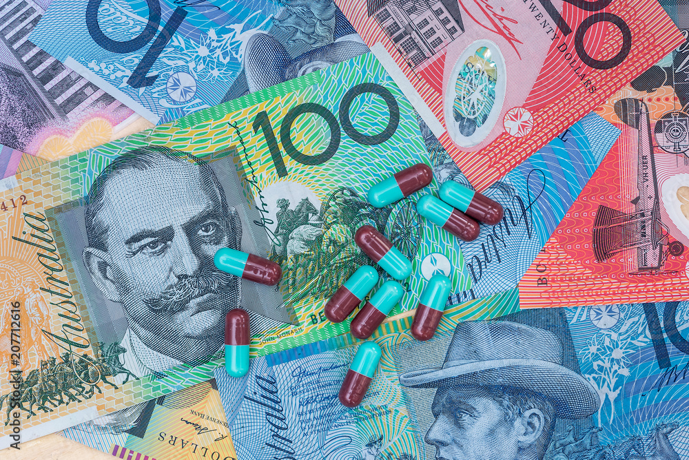 Fototapeta premium Colourful capsuled tablets on australia dollar banknotes