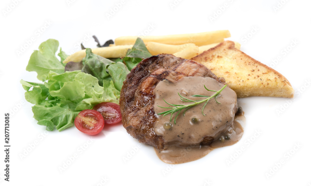 Grilled pork with french fries and salad isolated on white background Grilled pork with french fries and salad isolated on white background