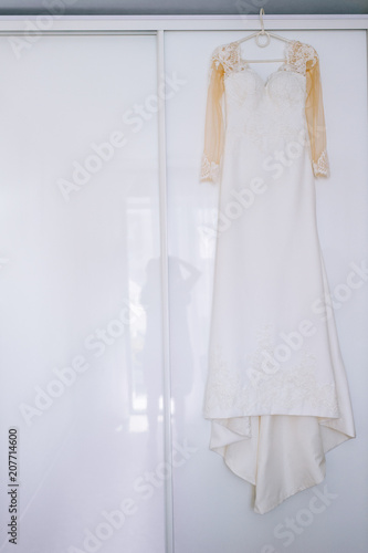 wedding dress on the white background of the window