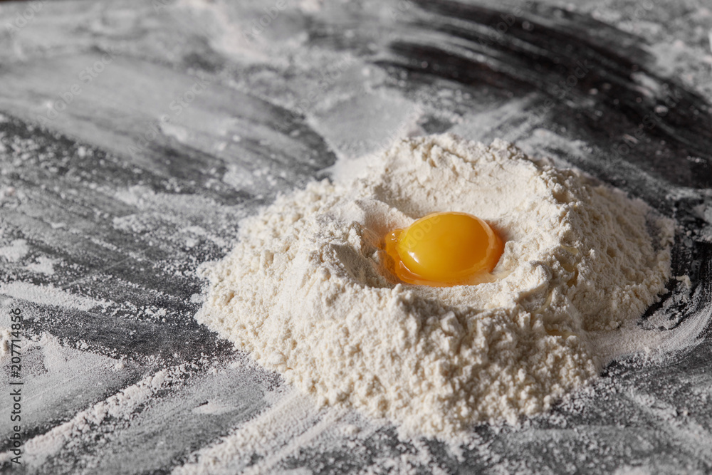 Pile of flour and egg on the kitchen table. Pile of flour and egg on the kitchen table.