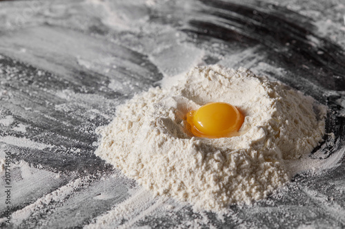 Pile of flour and egg on the kitchen table.