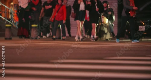 Unidentified people cross night street in Taipei, Taiwan