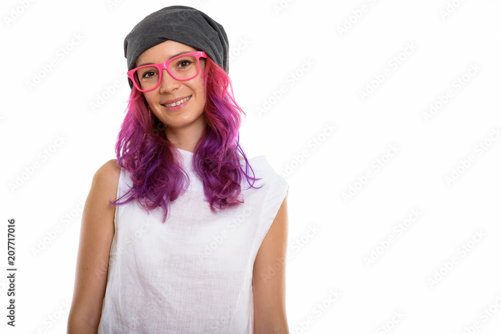 Studio shot of young happy woman smiling while wearing pink eyeg Studio shot of young happy woman smiling while wearing pink eyeg