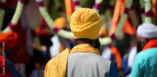 Sikh man with yellow turban during the religious celebration