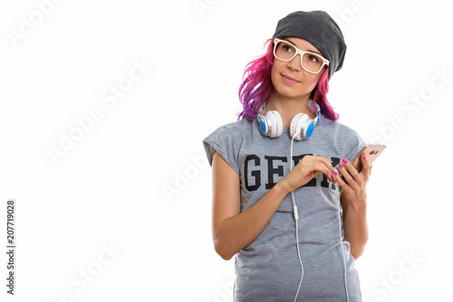Studio shot of geek girl holding mobile phone while thinking wit photo