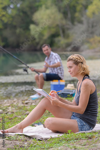 friends enjoying camping and fishing