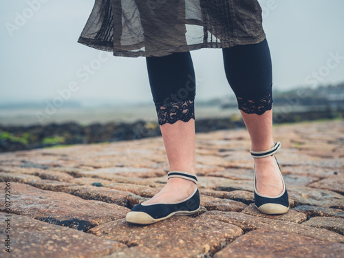 Feet of young woman walking outdoors