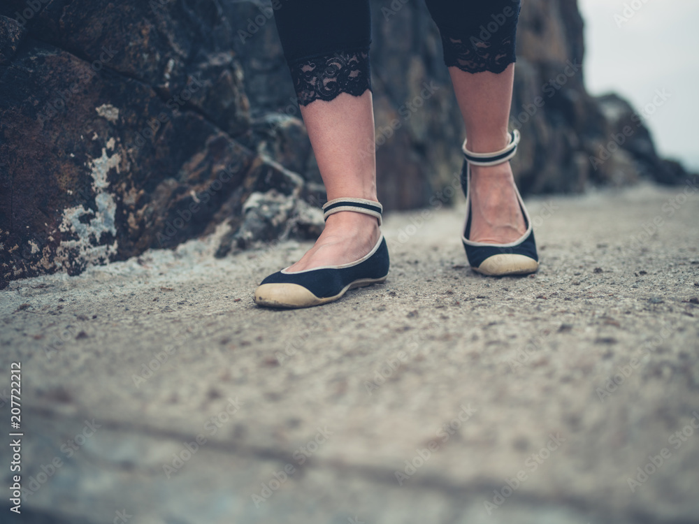 Feet of young woman walking outdoors Feet of young woman walking outdoors