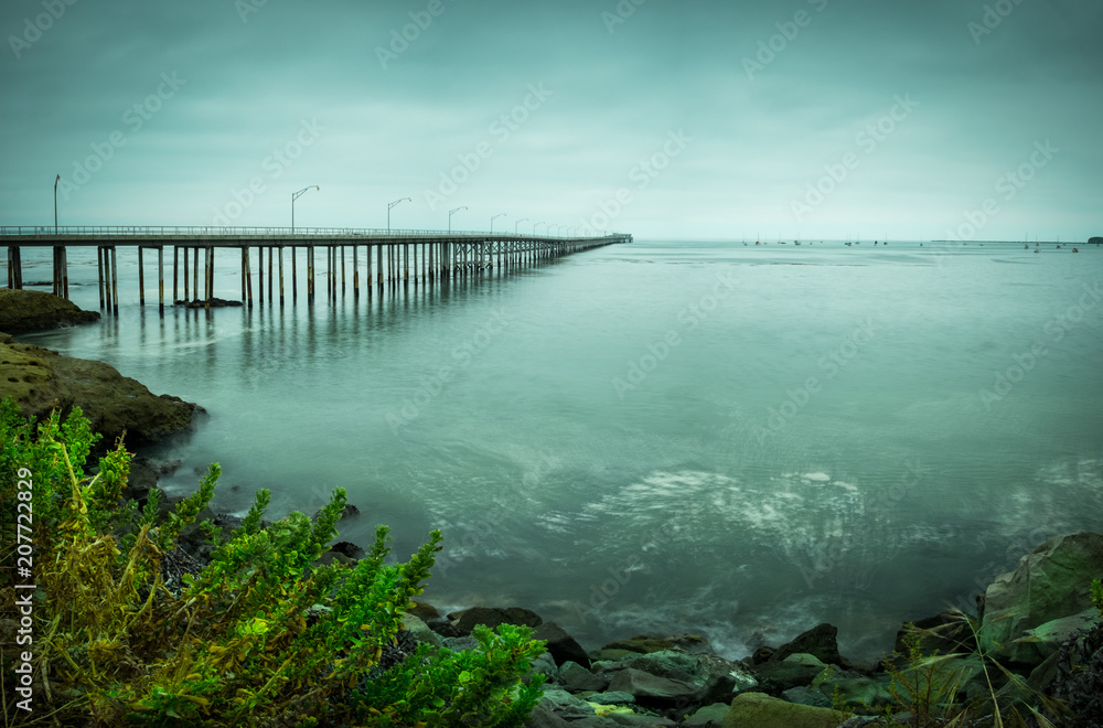 pier ocean water shore overcast cloudy seascape