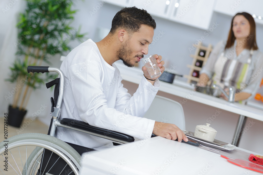 lovely wife cooking or her disabled husband