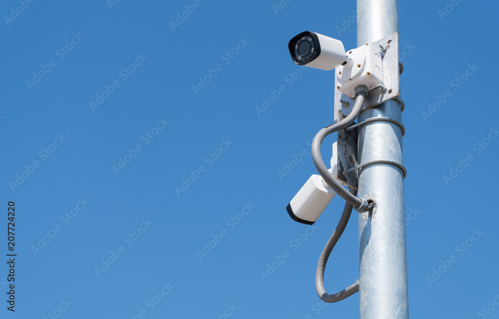 Security camera with blue sky.