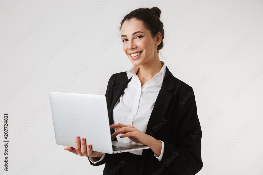 Smiling young business woman using laptop Smiling young business woman using laptop